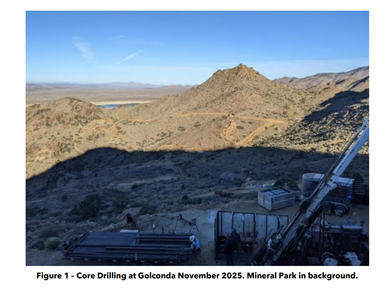 Core drilling rig at Golconda site with rugged desert hills and Mineral Park visible in the background