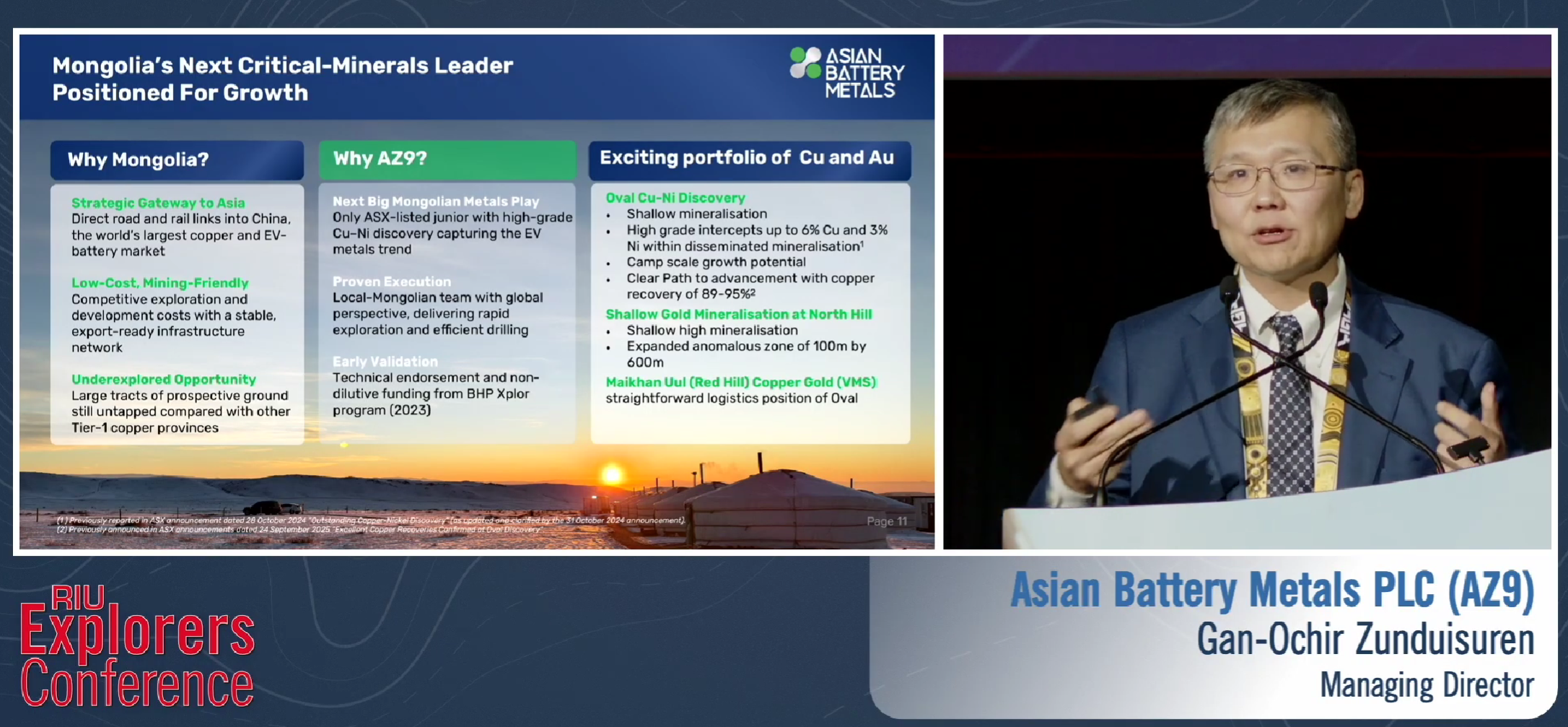 Slide on Mongolia critical minerals and AZ9 projects beside MD presenting at RIU Explorers Conference podium.