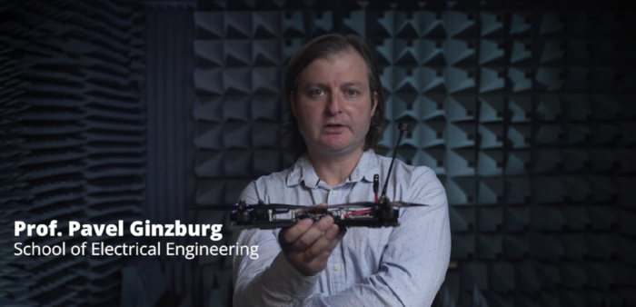 Professor Pavel Ginzburg from Tel Aviv University holds a drone inside an acoustic testing chamber.