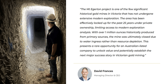 Miner stands in historic underground tunnel at Mt Egerton gold mine, with dark workings ahead and light behind.