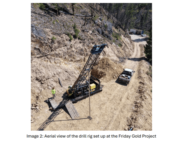 Aerial view of a drill rig operating beside a dirt access road at the Friday Gold Project.
