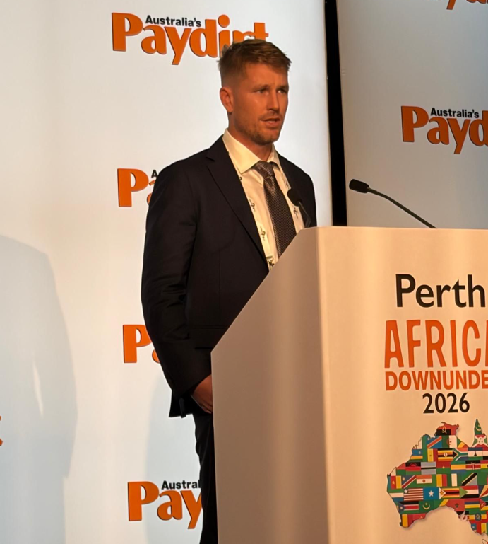 Speaker presenting at the podium during the 2026 Africa Down Under mining conference in Perth.