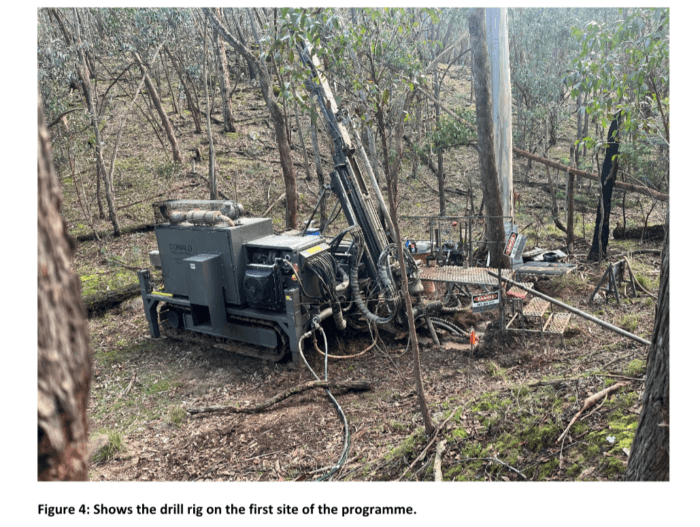 Drill rig operating at the first site of an exploration drilling programme in a wooded area.