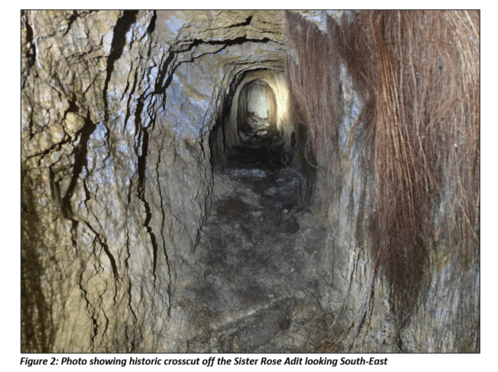 Historic underground crosscut at the Sister Rose Adit, showing narrow rock walls and exposed tree roots.