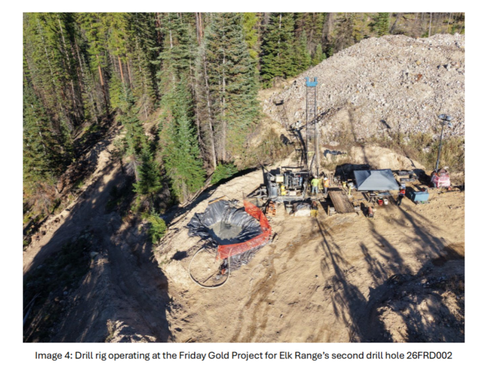 Aerial view of a drill rig operating at Elk Range Mining’s Friday Gold Project, drilling hole 26FRD002 in a forested area.
